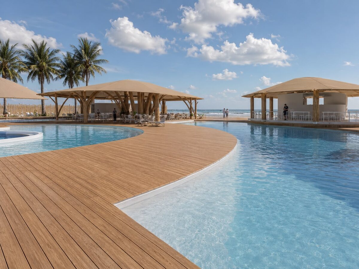 Piscina de AQUALODGE con el pool bar techado y la playa de Tumbes al fondo